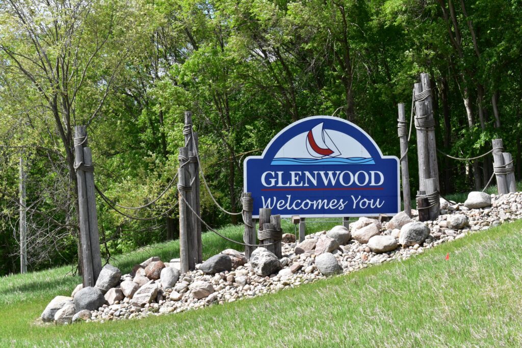 welcome sign on side of road for Glenwood, MN that reads Glenwood welcomes you