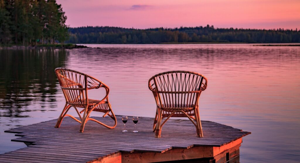 two-wooden-chairs-on-a-wood-pier-overlooking-a-lak-2023-11-27-05-35-17-utc